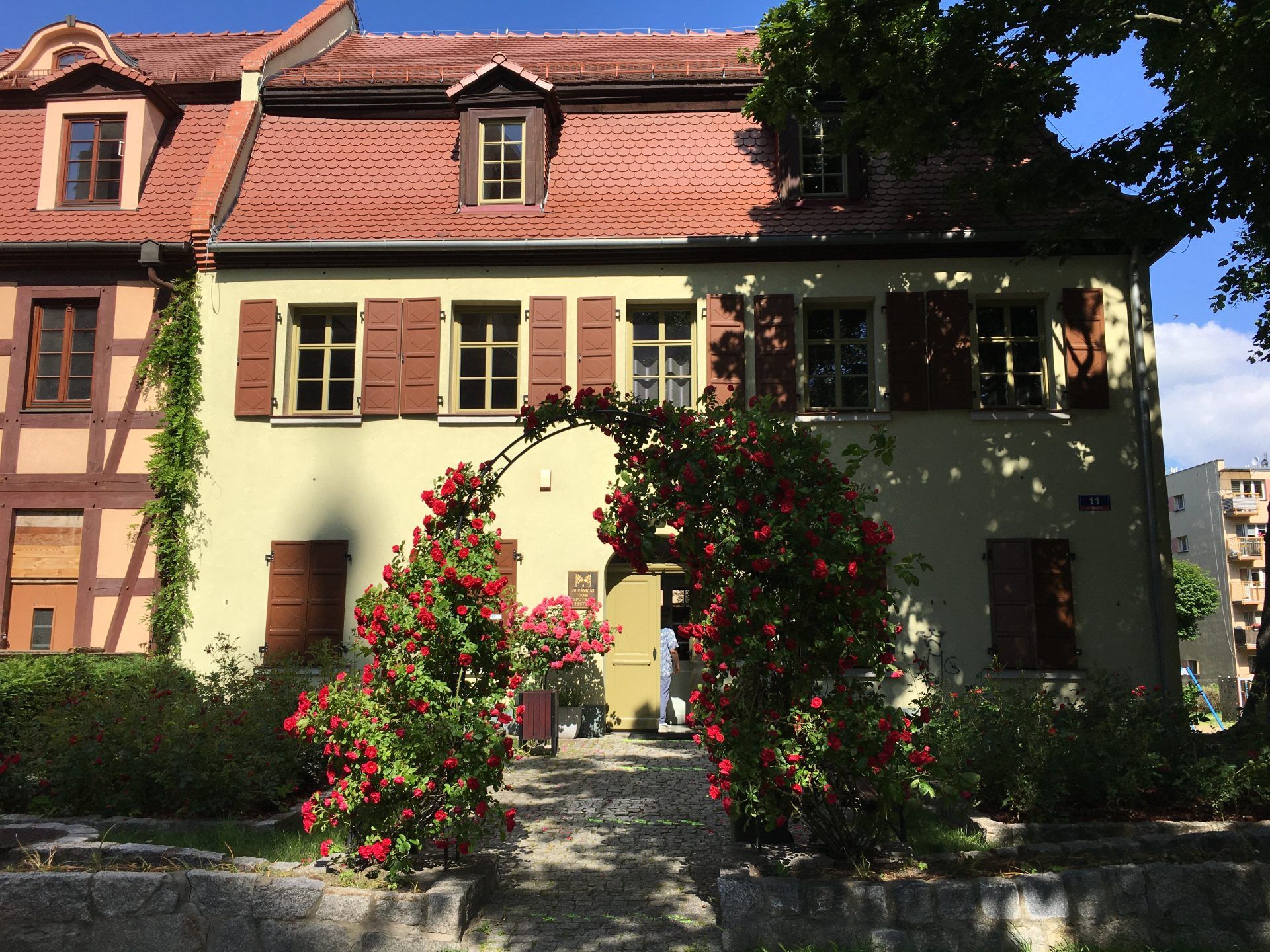 Zdjęcie elewacji zabytkowego budynku o konstrukcji szachulcowej z mansardowym dachem