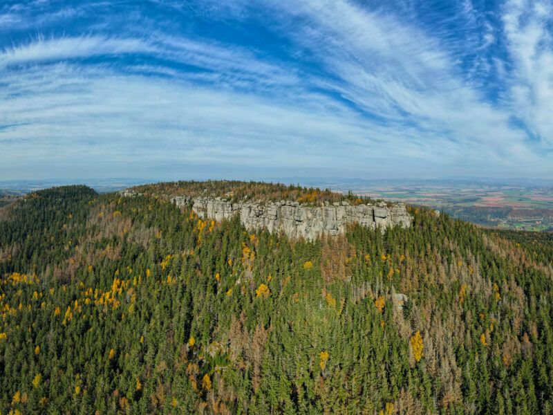 Panorama Gór Stołowych. Na zdjęciu wielkie masywne formacje skalne otoczone lasem widoczne z lotu ptaka