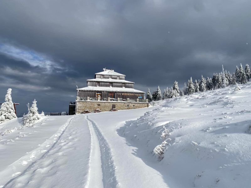 widok od dołu, zimą, na ośnieżone schronisko