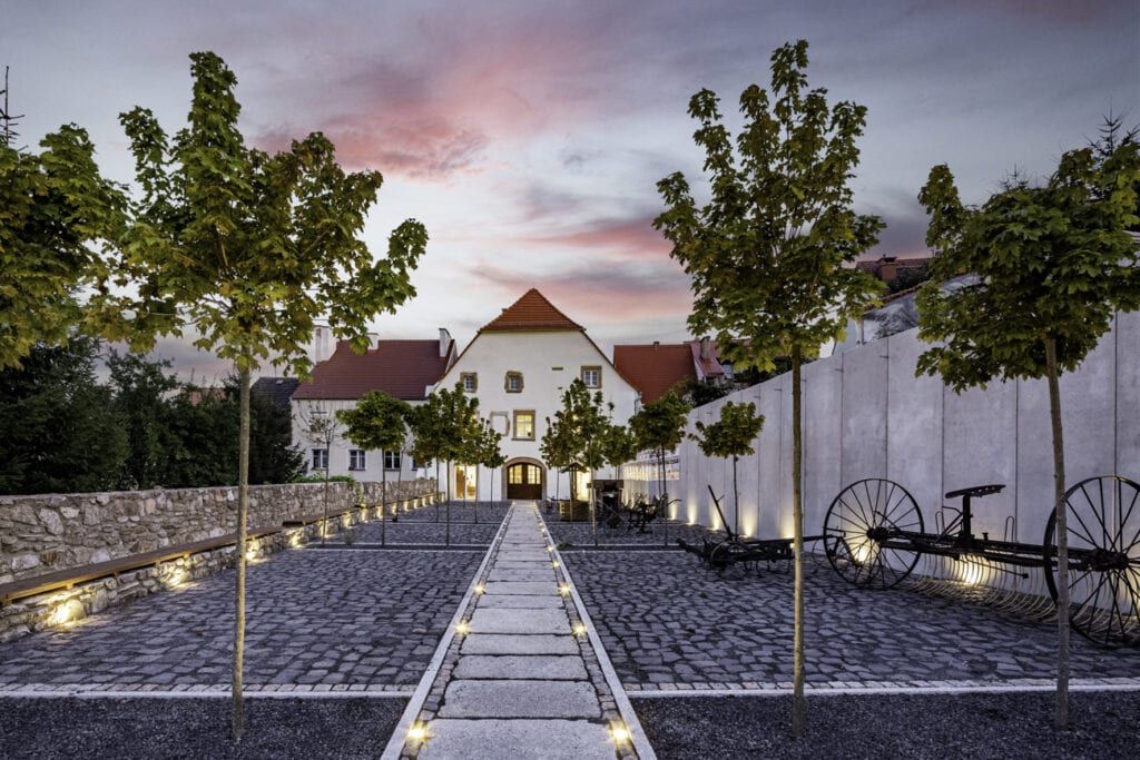 droga do muzeum oświetlona po bokach, zdjęcie wykonane o wschodzie słońca