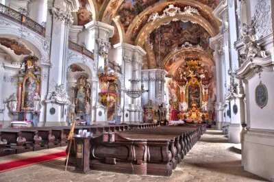 The interior of a large church with elaborate decoration