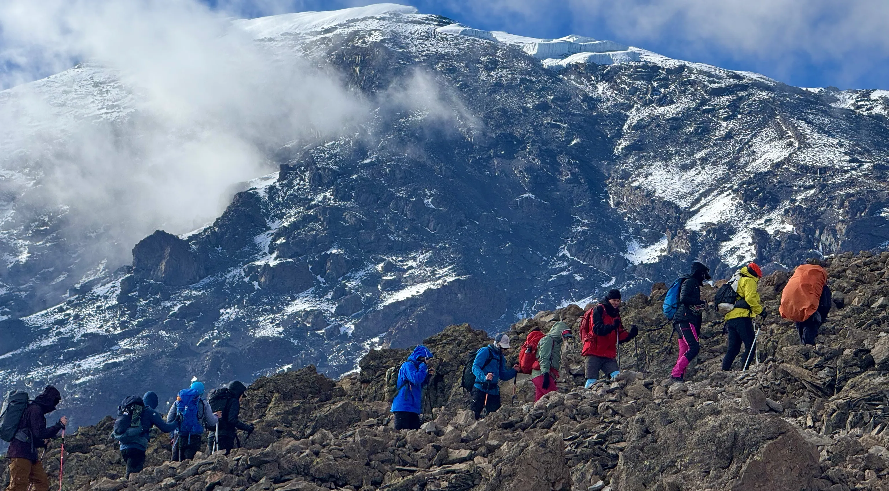 A group of hikers is walking uphill