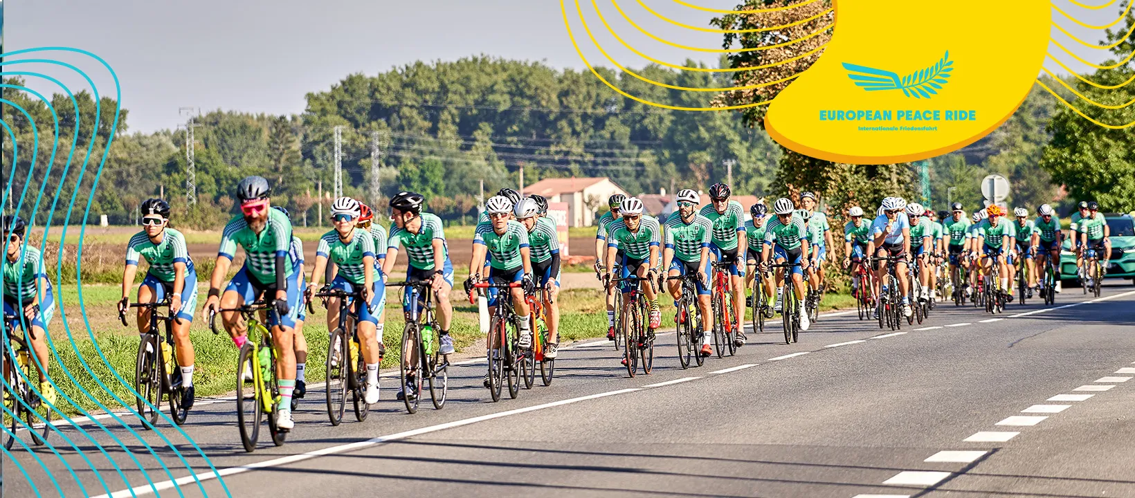 Kolumna kolarzy w zielonych strojach jedzie szosą podczas European Peace Ride, eskortowana przez organizatorów na tle lasów i wiejskiej zabudowy.